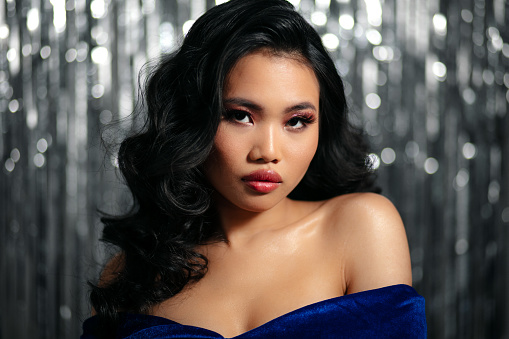 Alluring glamour asian woman with sensual look posing to a camera.