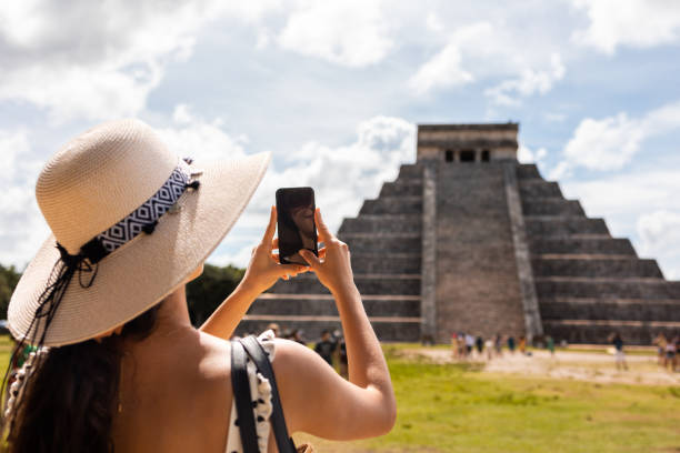 istock Tourist making photo of Chichen Itza pyramid in Mexico 1456642334