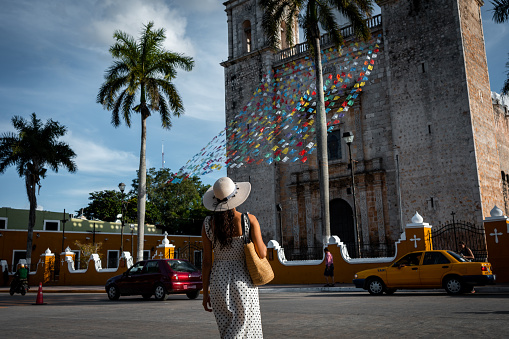 Woman looking at church in Valladolid town, Mexico