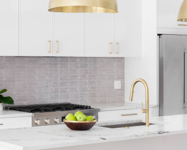 istock A white kitchen detail with gold light and faucet. 1456647841