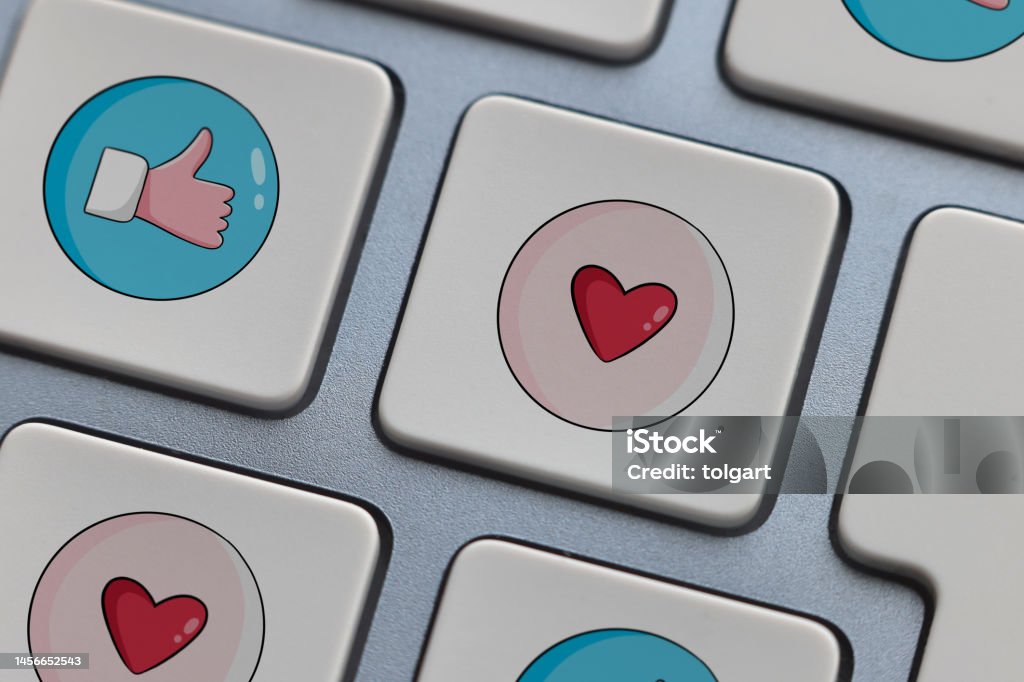 Thumbs up and heart shape icons on computer keyboard Like Button Stock Photo