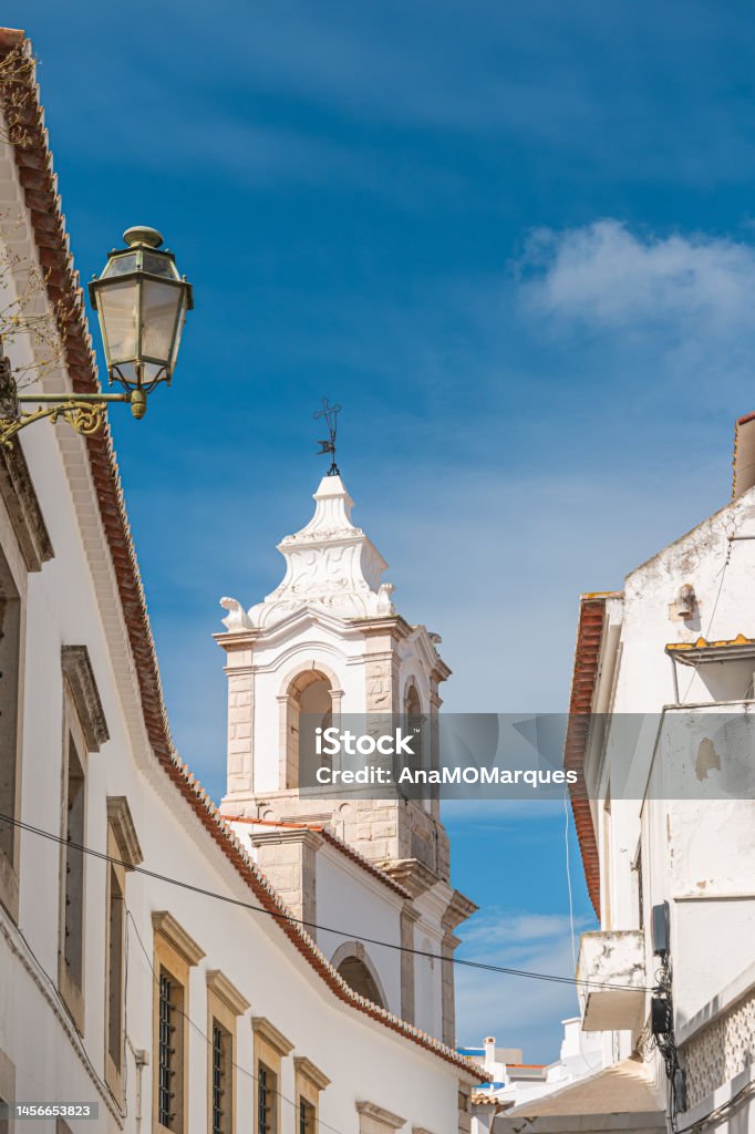 Detail of architecture of the streets of the city center with typical construction on a summer day Detail of architecture of the streets of the city center with typical construction on a summer day. View of street in the old town Faro. Algarve Stock Photo