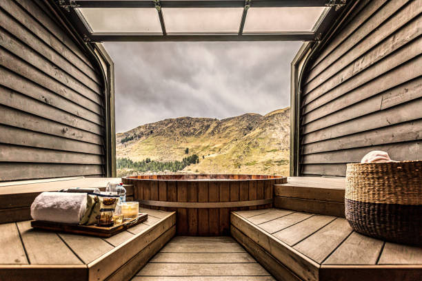 Hot tub overlooking valley Hot tub inside a wooden room. Overlooking a scenic valley. free standing bath stock pictures, royalty-free photos & images