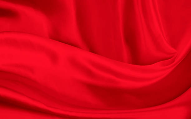 istock Black red satin dark fabric texture luxurious shiny that is abstract silk cloth background with patterns soft waves blur beautiful. 1456665013