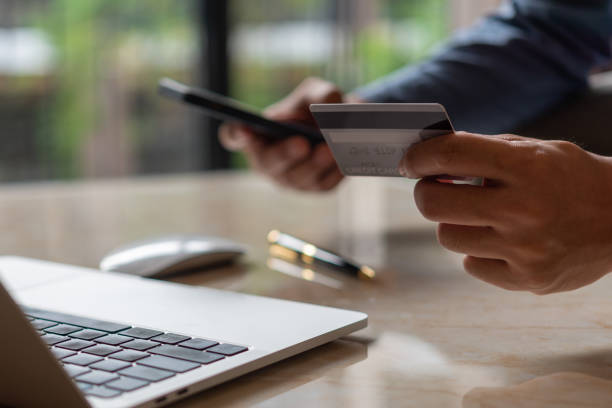 istock man hands holding credit card using internet payment laptop computer, online shopping digital banking, Business financial technology concept. 1456669564