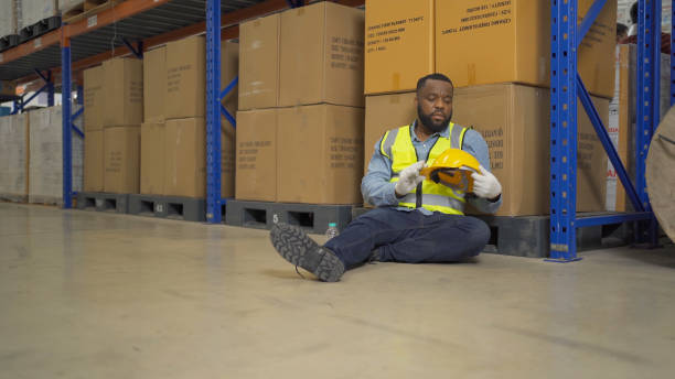 istock A fired man. Stressed upset depressed worried disappointed worker working in cargo container warehouse industry factory site in export, import, and transportation concept. Business people. 1456673431