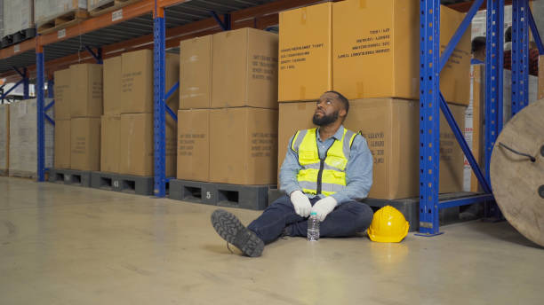 istock A fired man. Stressed upset depressed worried disappointed worker working in cargo container warehouse industry factory site in export, import, and transportation concept. Business people. 1456673454