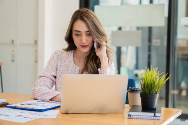 istock Asian businesswoman working with laptop computer and calculator financial documents on table make a plan analyzing financial reports business plan investment in the office 1456675665
