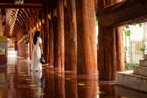 Asian woman at ancient Buddhist temple in Ayuthaya, Thailand