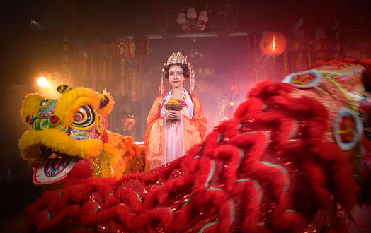 Chinese woman with yellow and red lions It is considered to enhance the prosperity for oneself on the occasion of the Chinese New Year festival every year and in Chinese, it means prosperous, fortunate, happy, prosperous