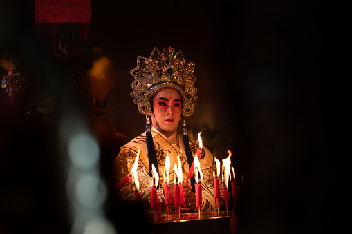 Male Chinese opera actors Light a candle to pray homage to the gods to enhance the prosperity for yourself on the occasion of the Chinese New Year festival.