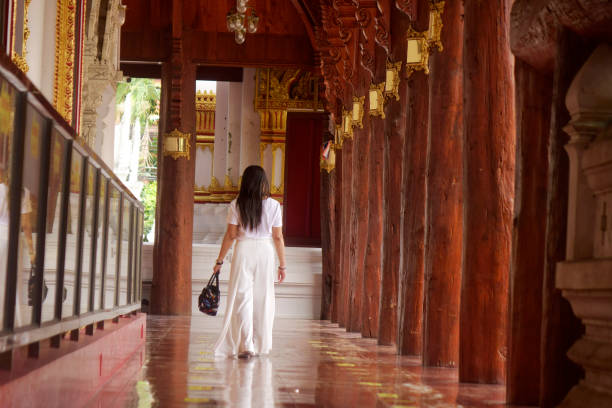 Asian woman at ancient Buddhist temple in Ayuthaya, Thailand