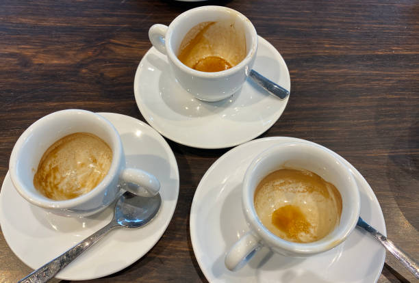 istock Three Empty Espresso Coffee Cups With Spoons On The Wooden Table 1456694615