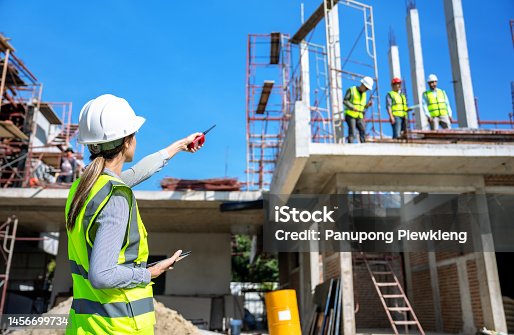 istock The engineer talks to the contractor to supervise and plan the work. 1456699734