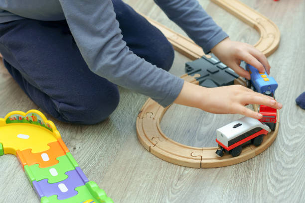 istock unrecognizable child playing with a wooden train 1456700873