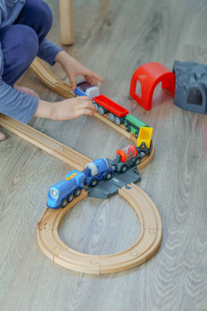istock unrecognizable child playing with a wooden train 1456700876