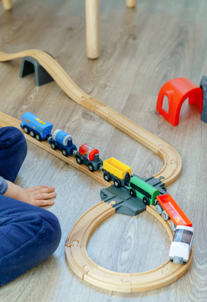 istock unrecognizable child playing with a wooden train 1456700883