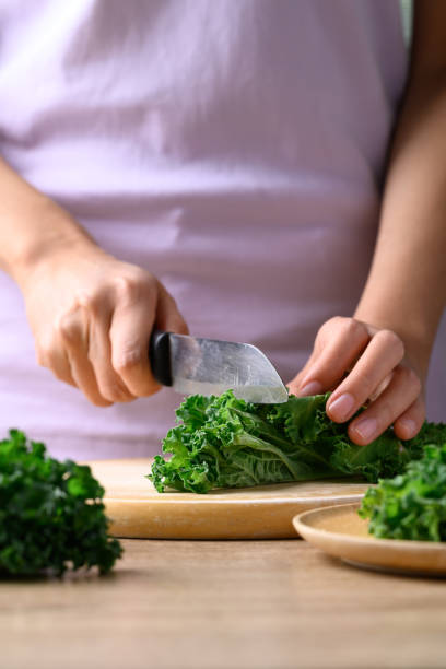istock Green Kale or leaf cabbage cutting on wooden board, Healthy vegetable 1456701033