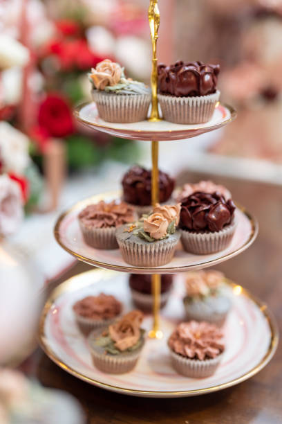 Cupcake Stand with Vanilla and Chocolate Buttercream Cupcakes, selective focus.