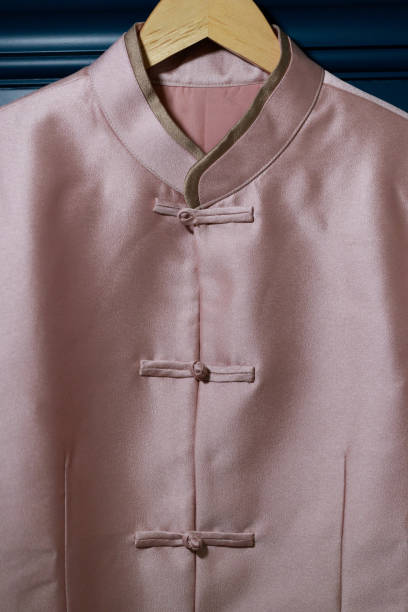 A traditional Tang suit design uses Chinese characters to represent good fortune and best wishes