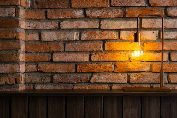 istock Bulb lamp against brick wall. Loft style design background. 1456709526