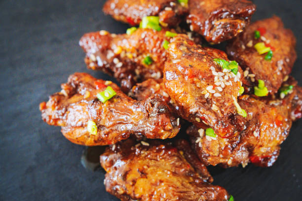istock fried chicken with garlic and sesame in caramel on a black tray. 1456711543