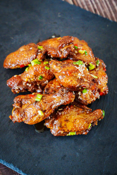 istock fried chicken with garlic and sesame in caramel on a black tray. 1456711581