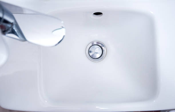 istock Open chrome faucet, tap washbasin in light room 1456711894