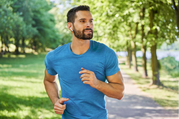 istock Male runner in park during sunny day in spring or summer 1456714079