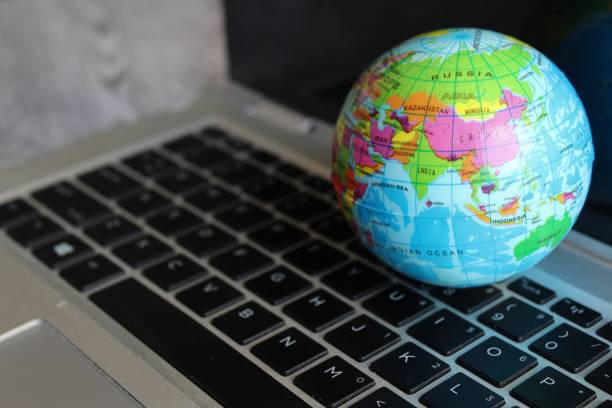 istock World globe map on top of laptop keyboard. 1456716613