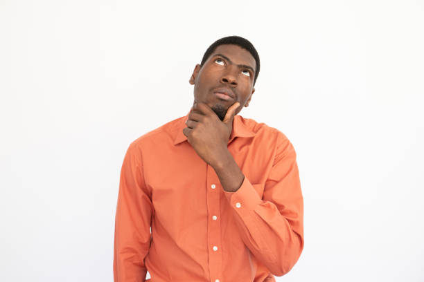 istock Portrait of thoughtful young man touching chin 1456717085