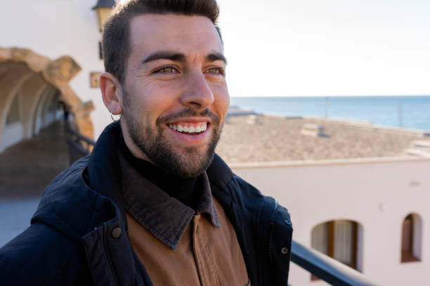 istock Smiling guy standing on top of aged building 1456717772