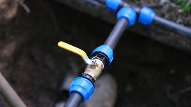 istock Pvc pipes with tap in ground on garden plot closeup 1456718997