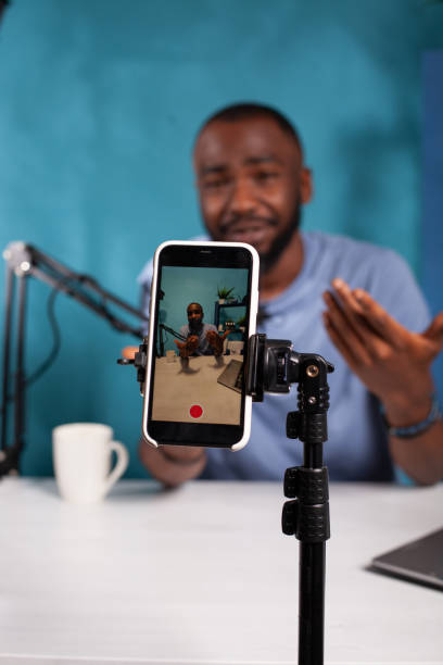 istock Veritical selective focus on live video podcast setup recording content creator moving hands 1456719361