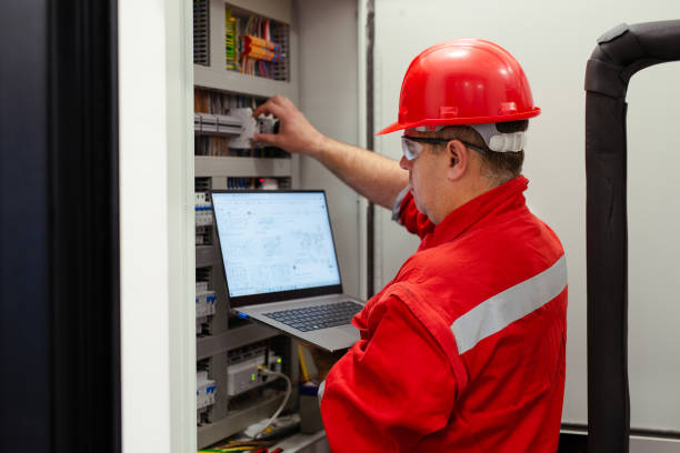 istock Electrician looking at plans for power junction box 1456720256