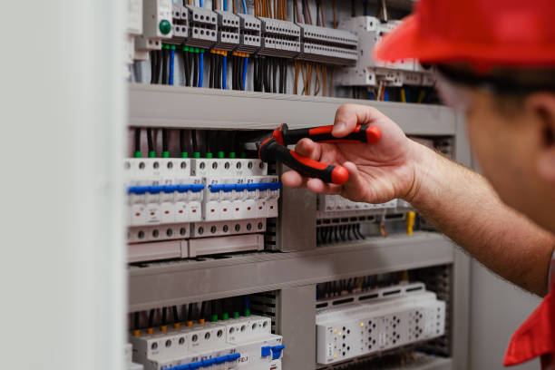 istock Electrical wiring repair. Repairman repairs electrical panel. 1456720298