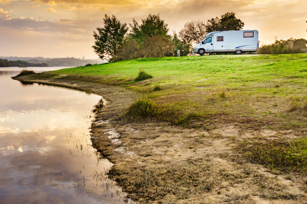 istock Rv caravan on lake shore at sunset. Autumn time. 1456720590