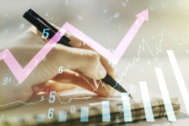istock Abstract creative financial graph with upward arrow and woman hand writing in notebook on background, forex and investment concept. Multiexposure 1456721691