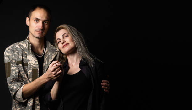 istock military man and his wife on a black background 1456722687