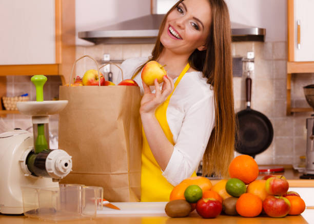 istock Woman in kitchen preparing fruits for juicing 1456722778