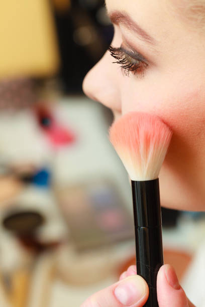 istock Close up woman getting make up, blush 1456725368