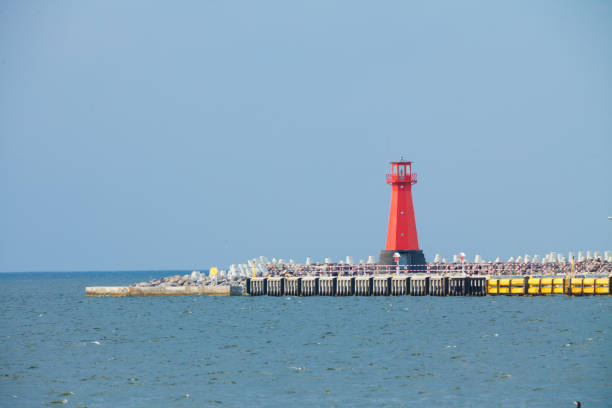 istock Red lighthouse on promenade near sea 1456725546