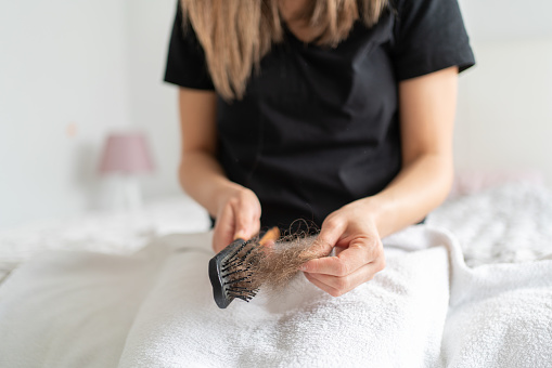 Woman Cleaning Her Hair With A HairBrush İn Her Hand
