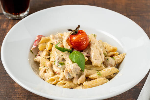 istock Penne arrabiata pasta with chicken on a white porcelain plate 1456726874
