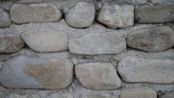 istock Neatly stacked rough cut stone wall seamless texture background 1456727380
