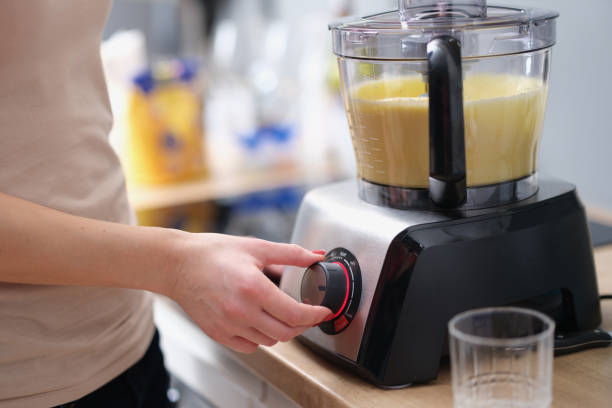 istock Woman is making smoothie or mixing dough in electric blender 1456728227
