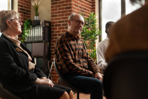 istock People talking to therapist at aa group therapy meeting, sharing addiction problems 1456729069