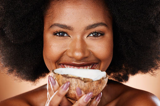 Beauty, skincare and portrait of girl with coconut for antioxidants, facial treatment or anti aging. Hydration skin glow, body care and face of black woman with fruit product for natural healthcare