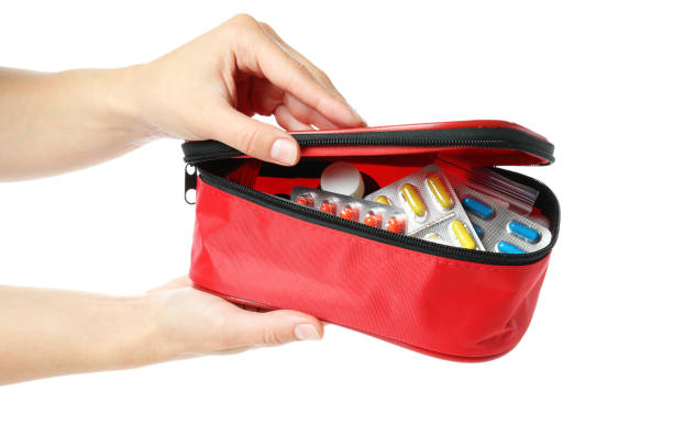istock Female hands hold first aid medical kit, isolated on white background 1456731942