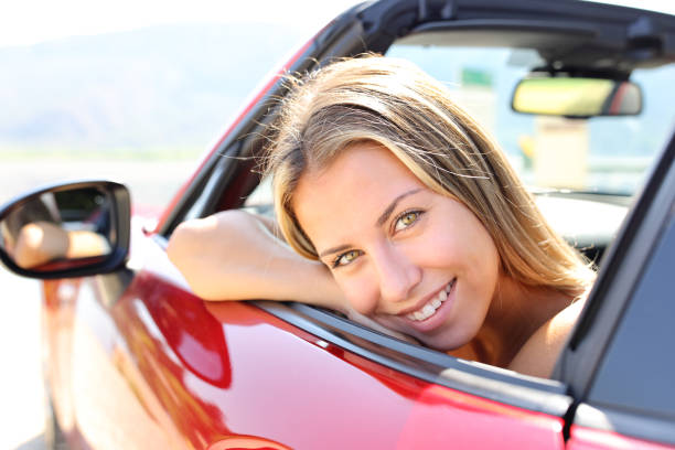 istock Happy convertible car driver looks at you 1456732027